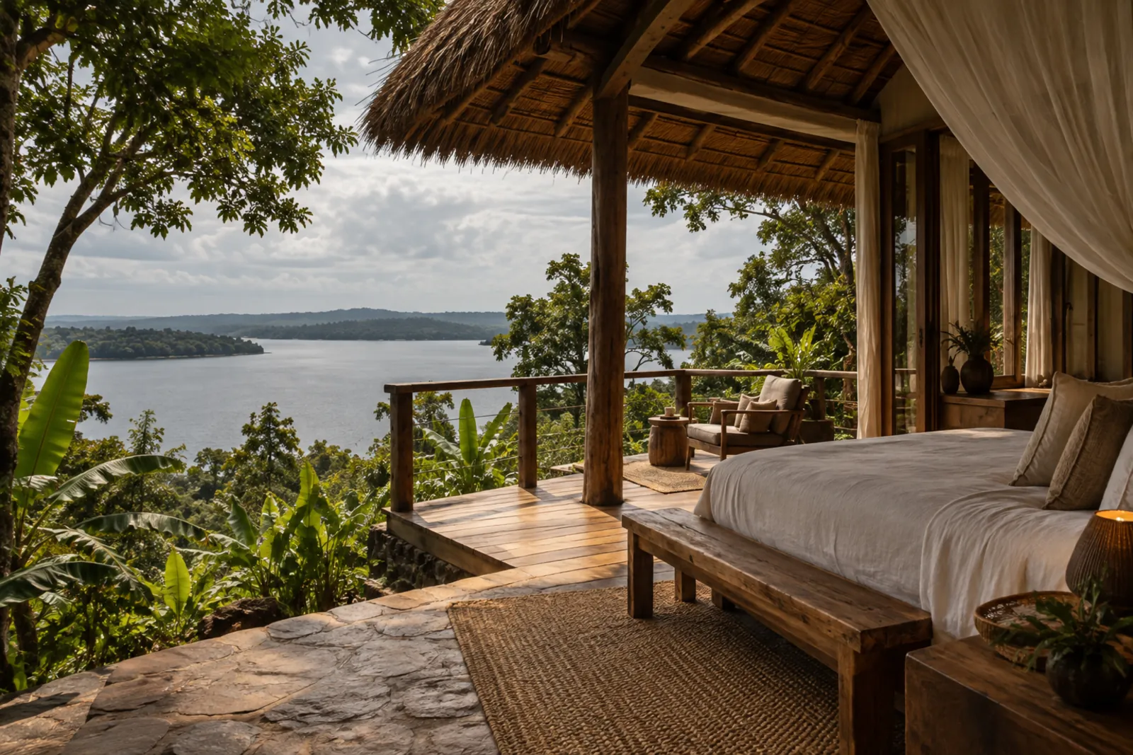 The veranda of a cabin above the lake, with a thatched roof and open water in the distance